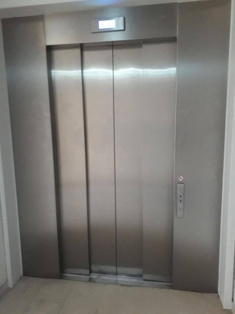 Moderner Aufzug mit Edelstahltüren in einem Gebäude, bereit zur Nutzung auf einer Etage.