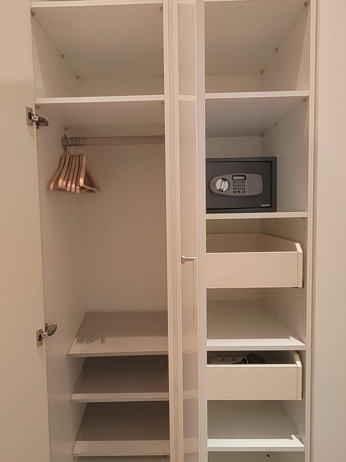 Geräumiger Einbauschrank mit Regalen, Kleiderstange und integriertem Safe.