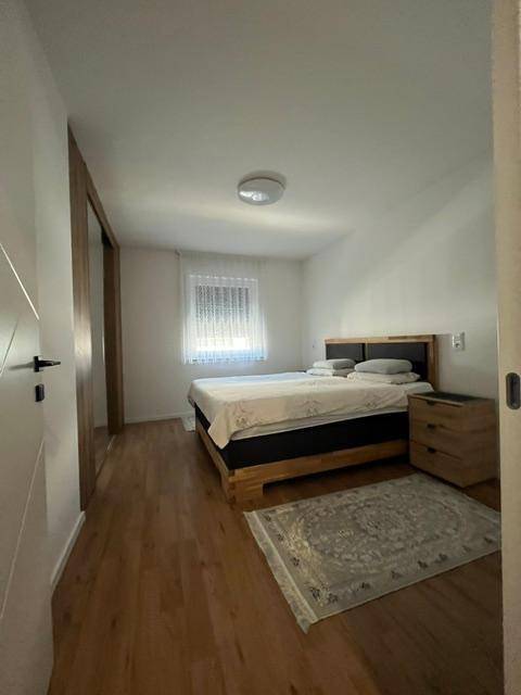 Gemütliches Schlafzimmer mit Holzboden, Doppelbett und Einbauschränken entlang einer Wand.