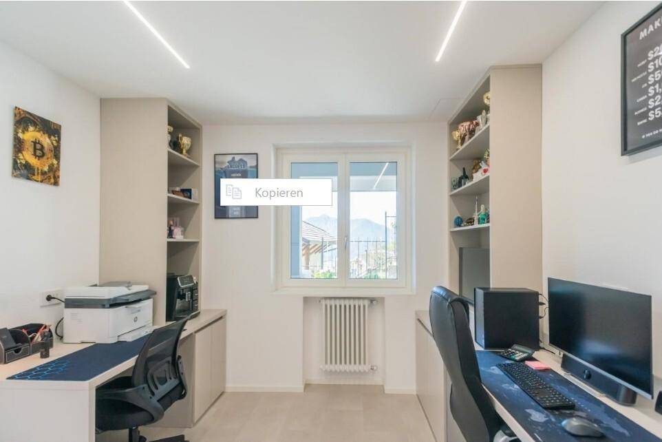 Funktionales Heimbüro mit zwei Arbeitsplätzen, Regalen und viel natürlichem Licht.
