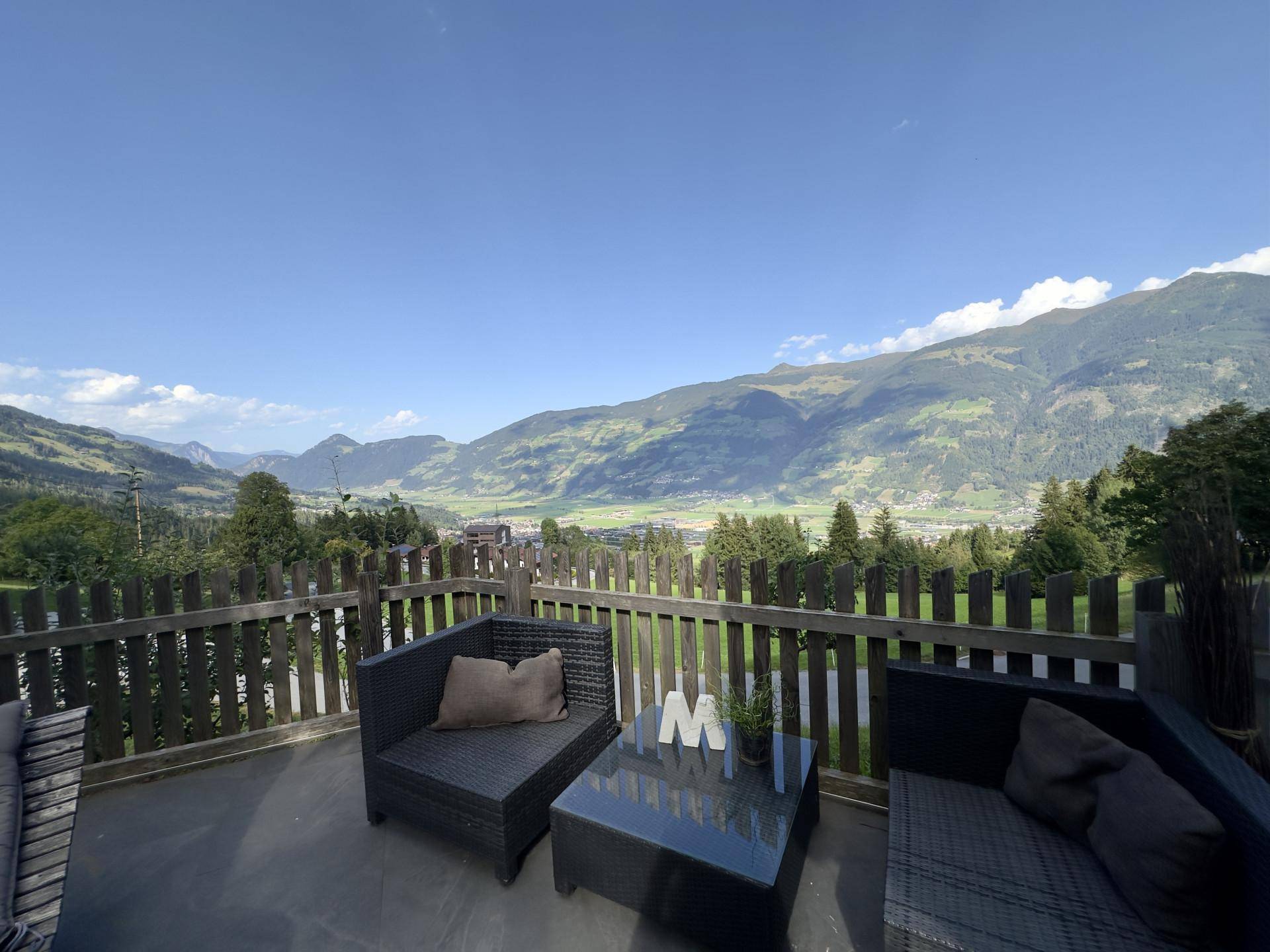 Geräumige Terrasse mit bequemen Sitzgelegenheiten und einem atemberaubenden Blick auf die umliegende Berglandschaft.