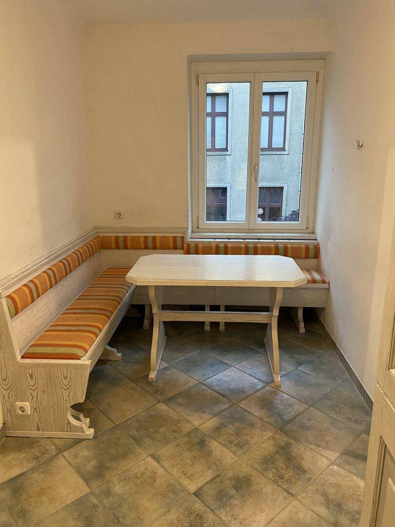 Heller Essbereich in der Küche mit Eckbank und Tisch am Fenster, ideal für Mahlzeiten.