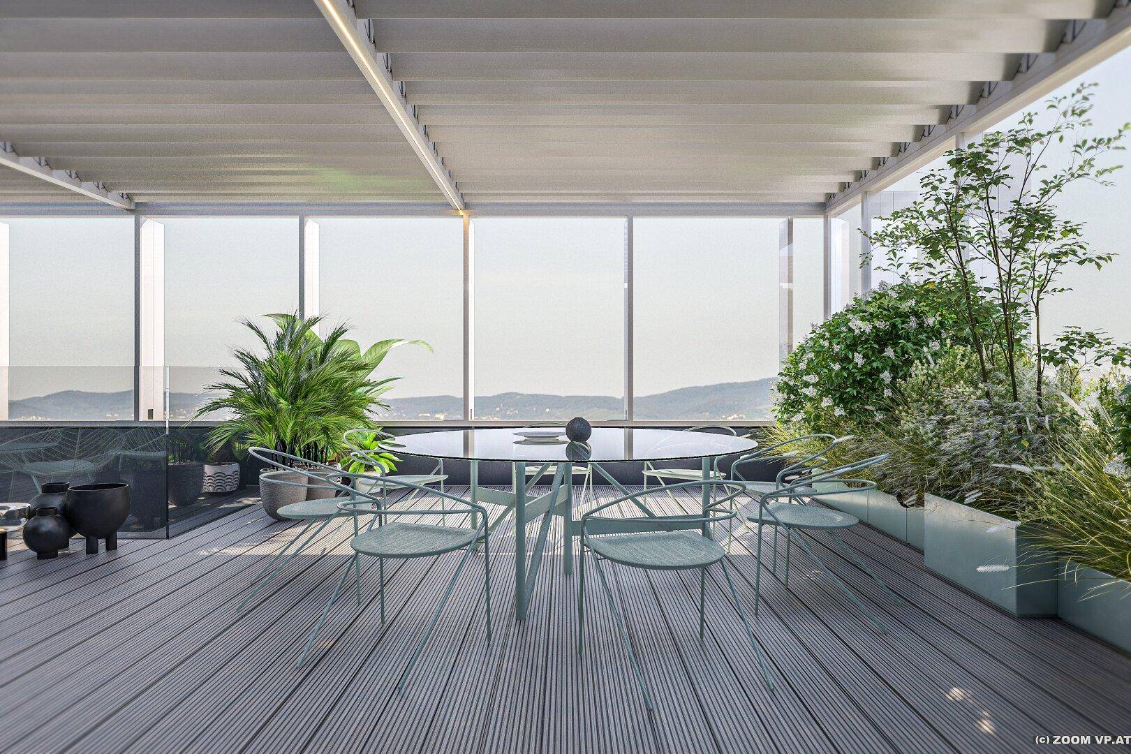 Geräumige Dachterrasse mit Essbereich, Pflanzen und weitem Blick über die Landschaft.