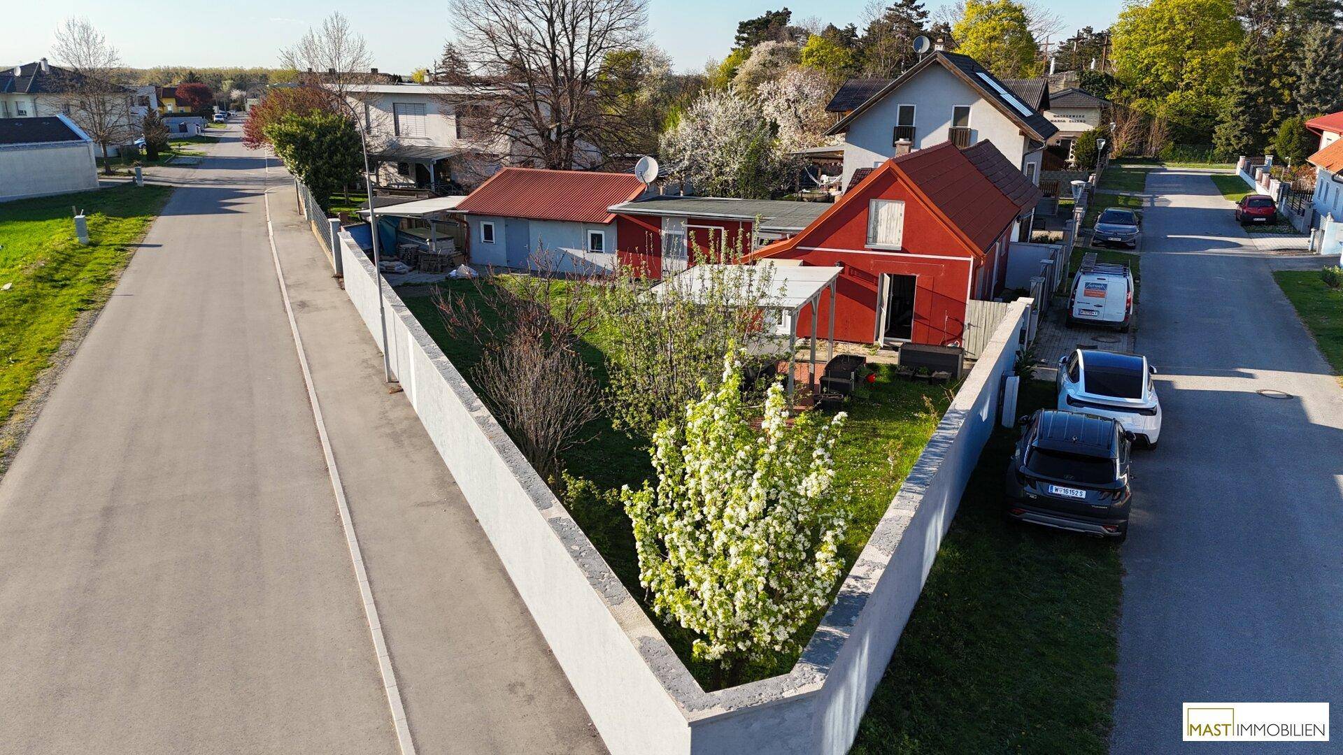 Luftaufnahme des Anwesens mit Haus, Garten und angrenzender Straße in ländlicher Umgebung.