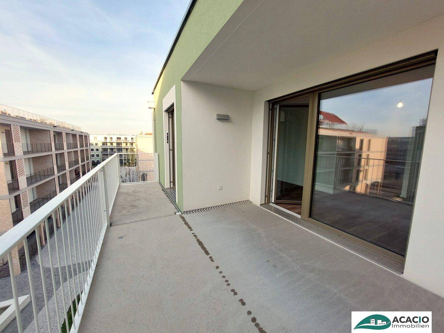 Breiter Balkon mit weitem Blick über die Nachbarschaft und moderne Architektur.