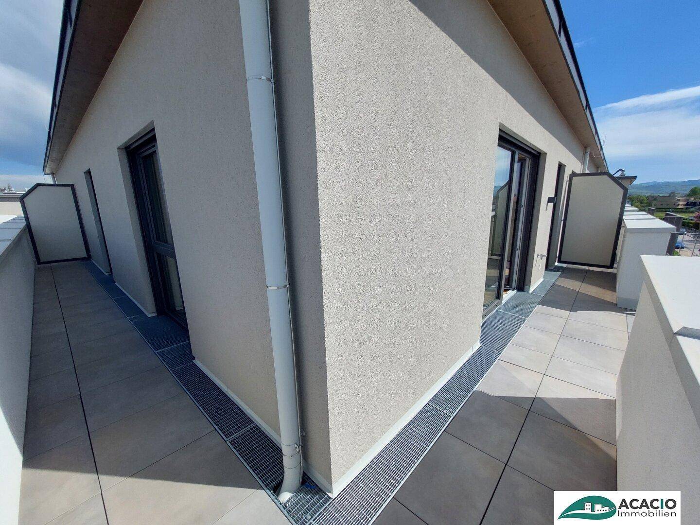 Geräumiger Balkon mit Fliesenboden und moderner Brüstung, ideal für Entspannung.