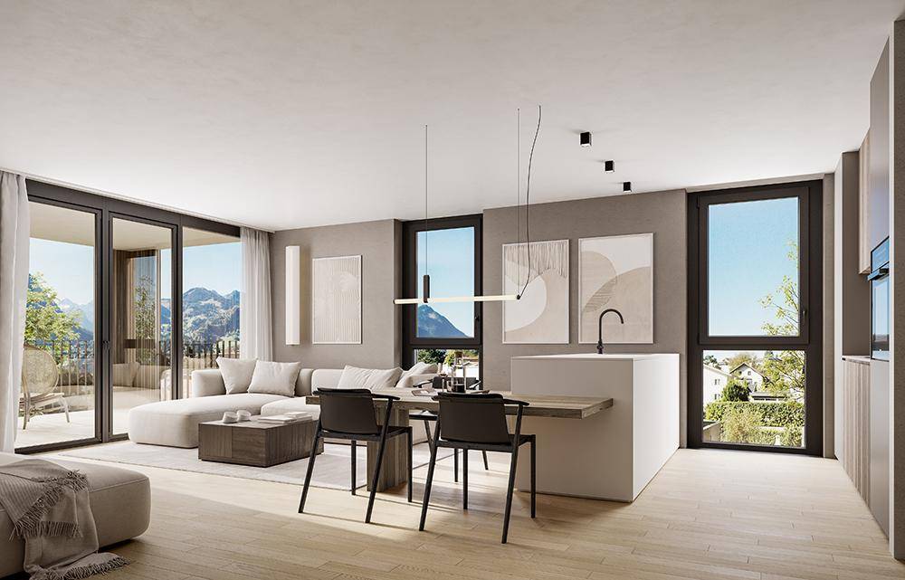 Heller, offener Wohn-Essbereich mit moderner Küche, Holzboden und Panoramablick auf die Berge.