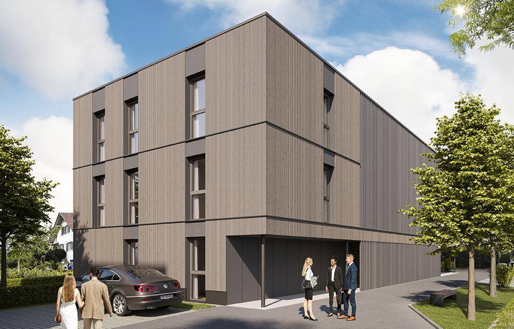 Moderne Gebäudefassade mit Holzverkleidung, großen Fenstern und Zufahrt zum Parkbereich.