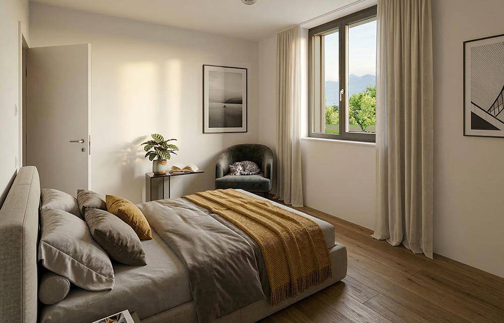 Helles Schlafzimmer mit Holzboden, großem Fenster und Blick auf die grüne Landschaft.
