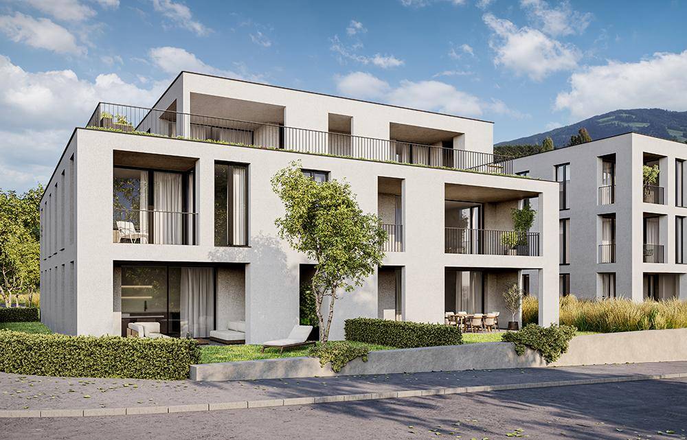 Zeitgenössischer Wohnkomplex mit Balkonen und Terrassen, eingebettet in eine grüne Hügellandschaft.