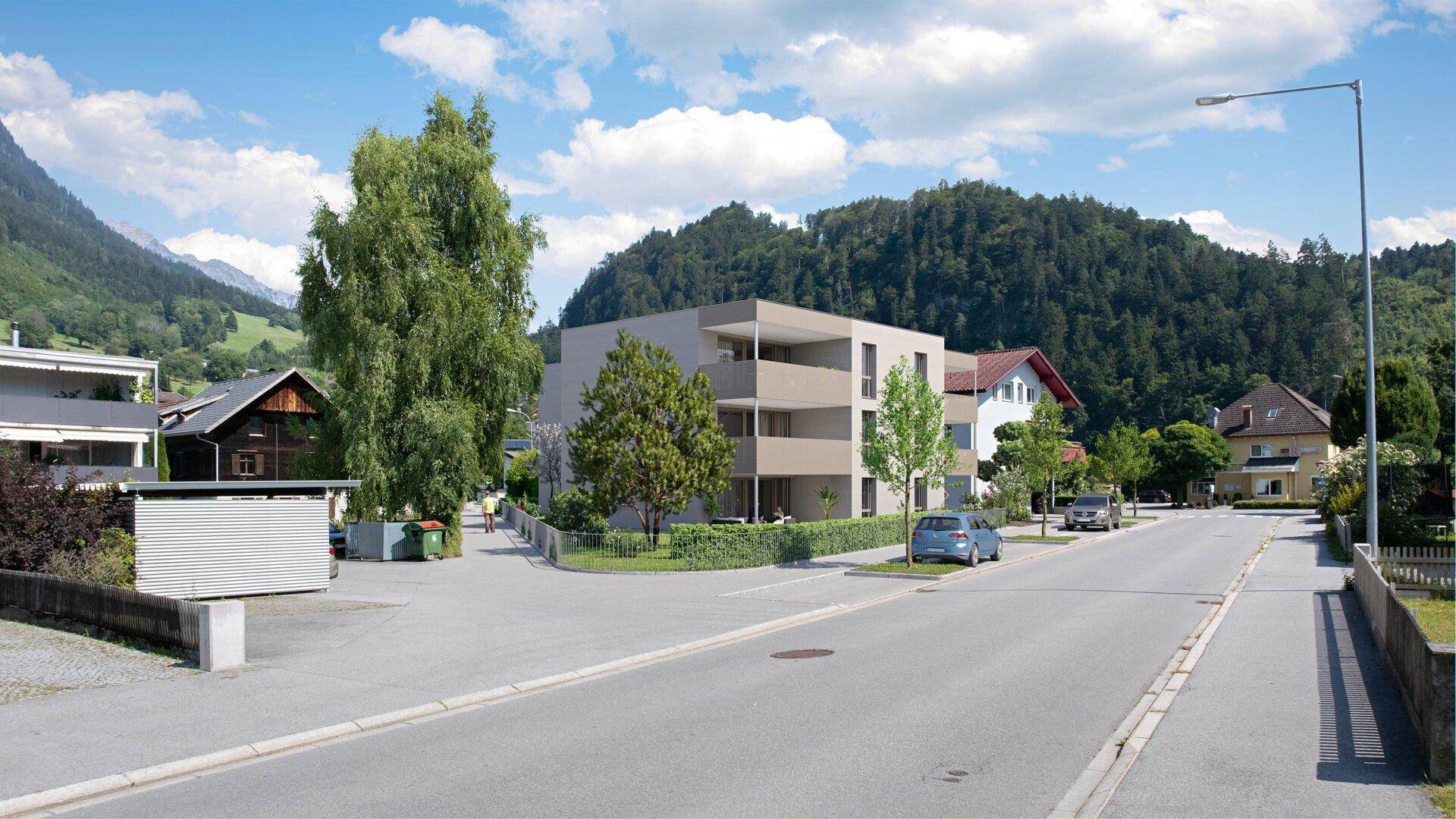 Übersicht des modernen Wohngebäudes in seiner ländlichen Umgebung mit Bergpanorama.