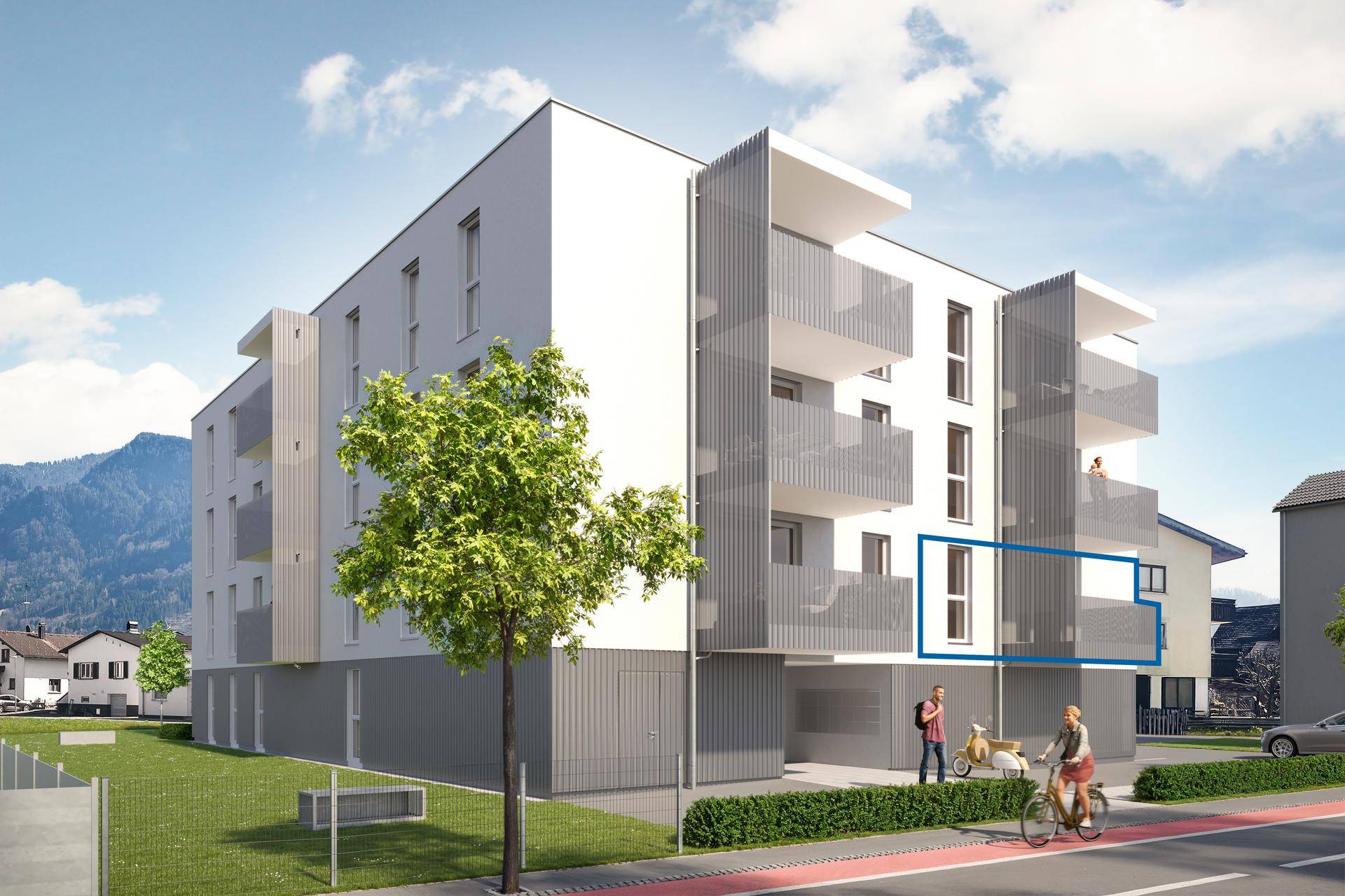 Moderne Wohnanlage mit Balkonen und einer ansprechenden Fassade vor bergiger Kulisse.