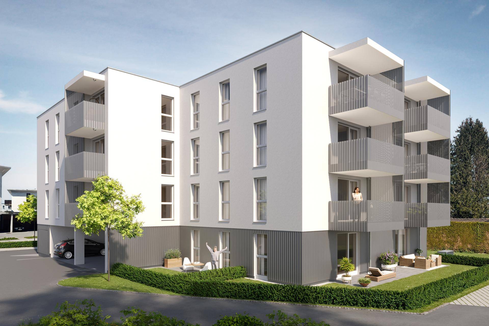 Moderne Wohnanlage mit Balkonen und Terrassen, umgeben von gepflegten Grünflächen.
