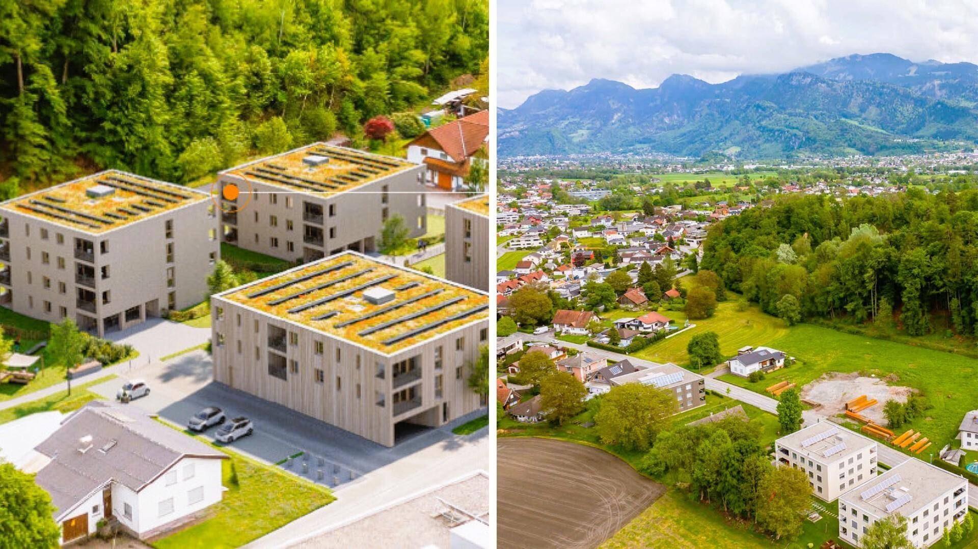 Luftaufnahme einer modernen Wohnsiedlung mit Solaranlagen und umliegender Naturlandschaft mit Bergen.