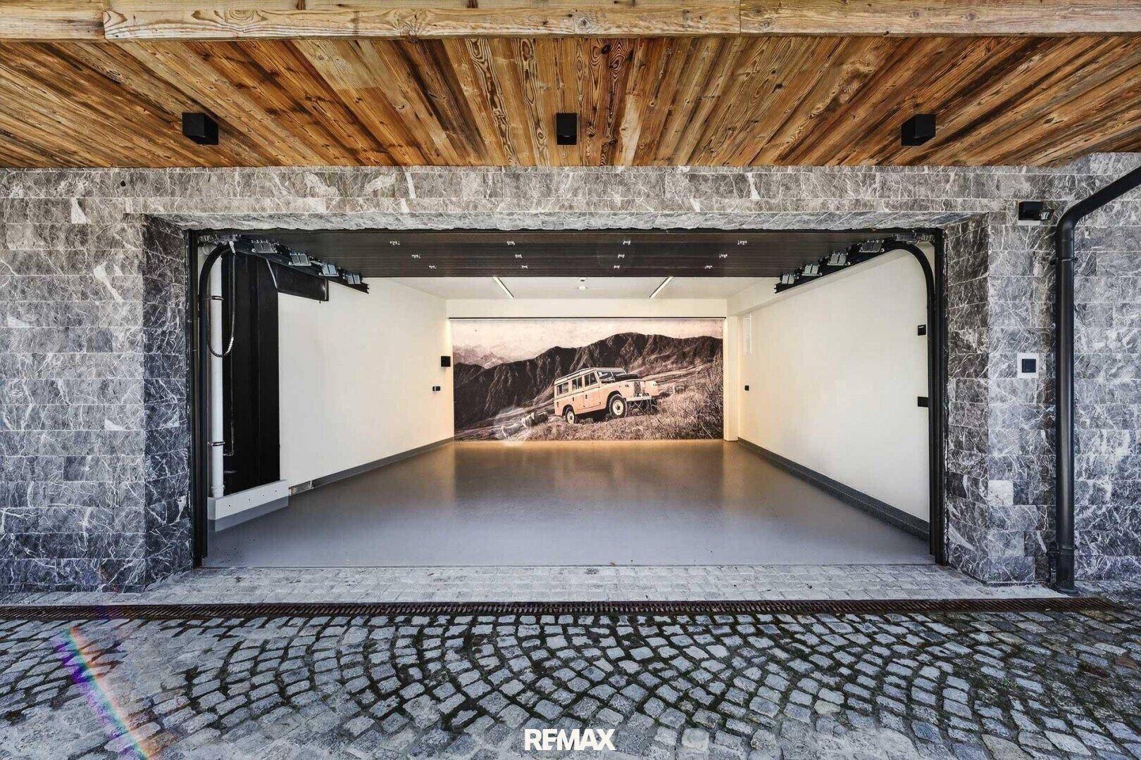 Geräumige Garage mit Steinfassade, Holzbalkendecke und dekorativer Wandgestaltung.