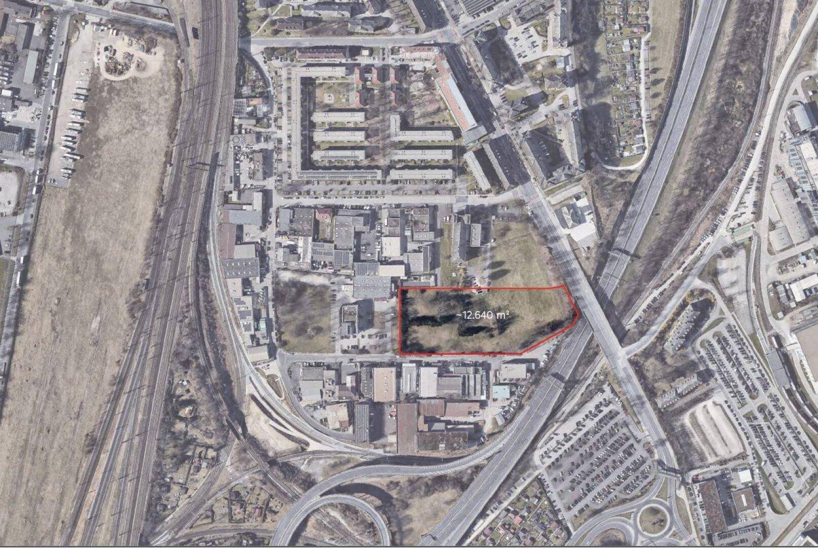 Luftaufnahme eines Industriegebiets mit Autobahnanschluss und markiertem Grundstück von 12.640 m².