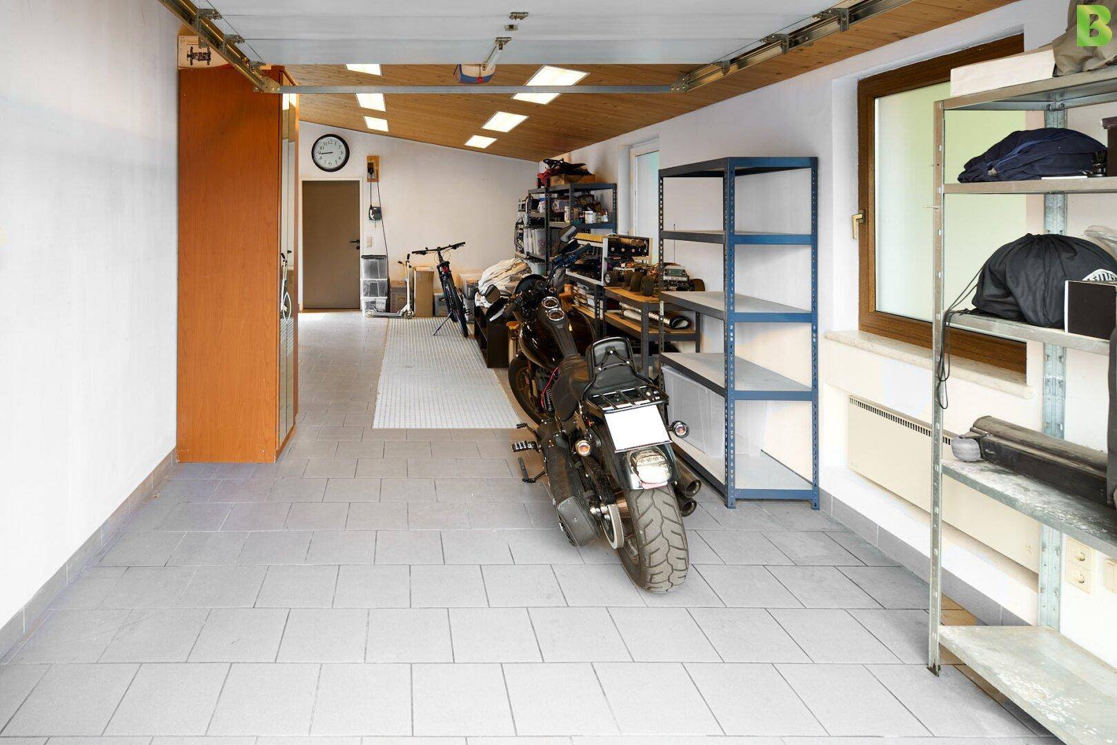 garage with an oversized workshop, hobby room and half bath