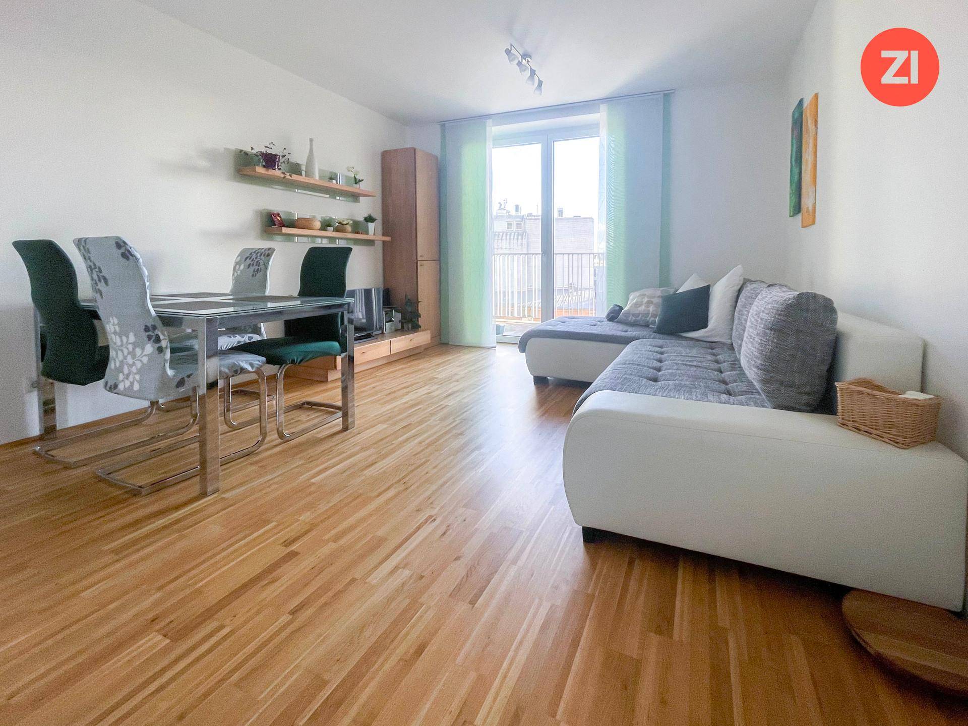 Heller Wohn- und Essbereich mit Zugang zum Balkon und modernem Mobiliar.