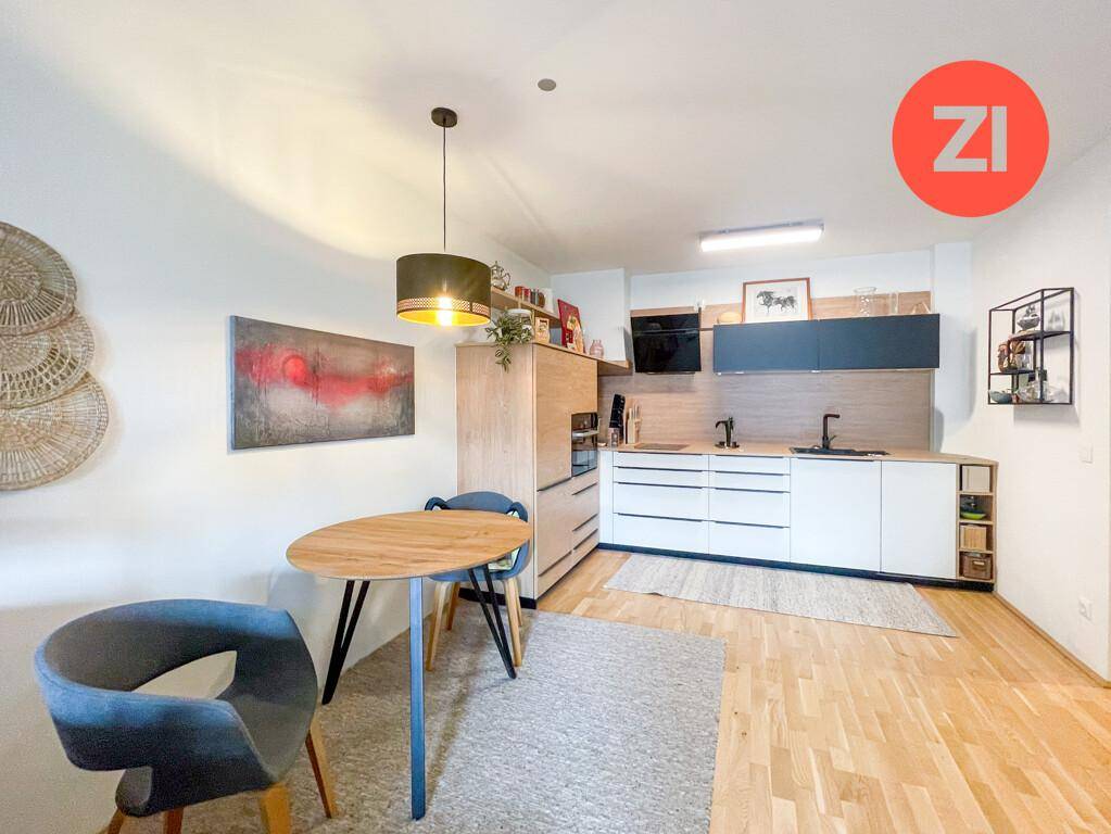 Moderne Einbauküche mit Holzelementen, weißen Fronten und Essbereich.