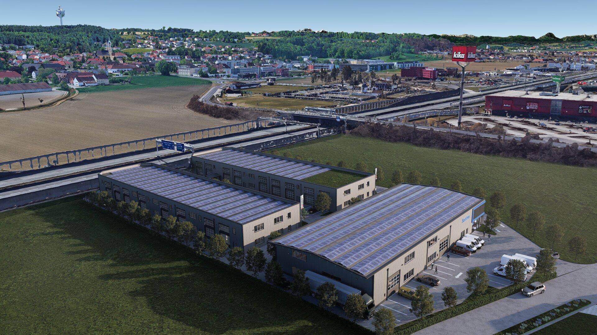 Luftaufnahme eines Gewerbegebiets mit Gebäuden, Solaranlagen und Autobahnanbindung.