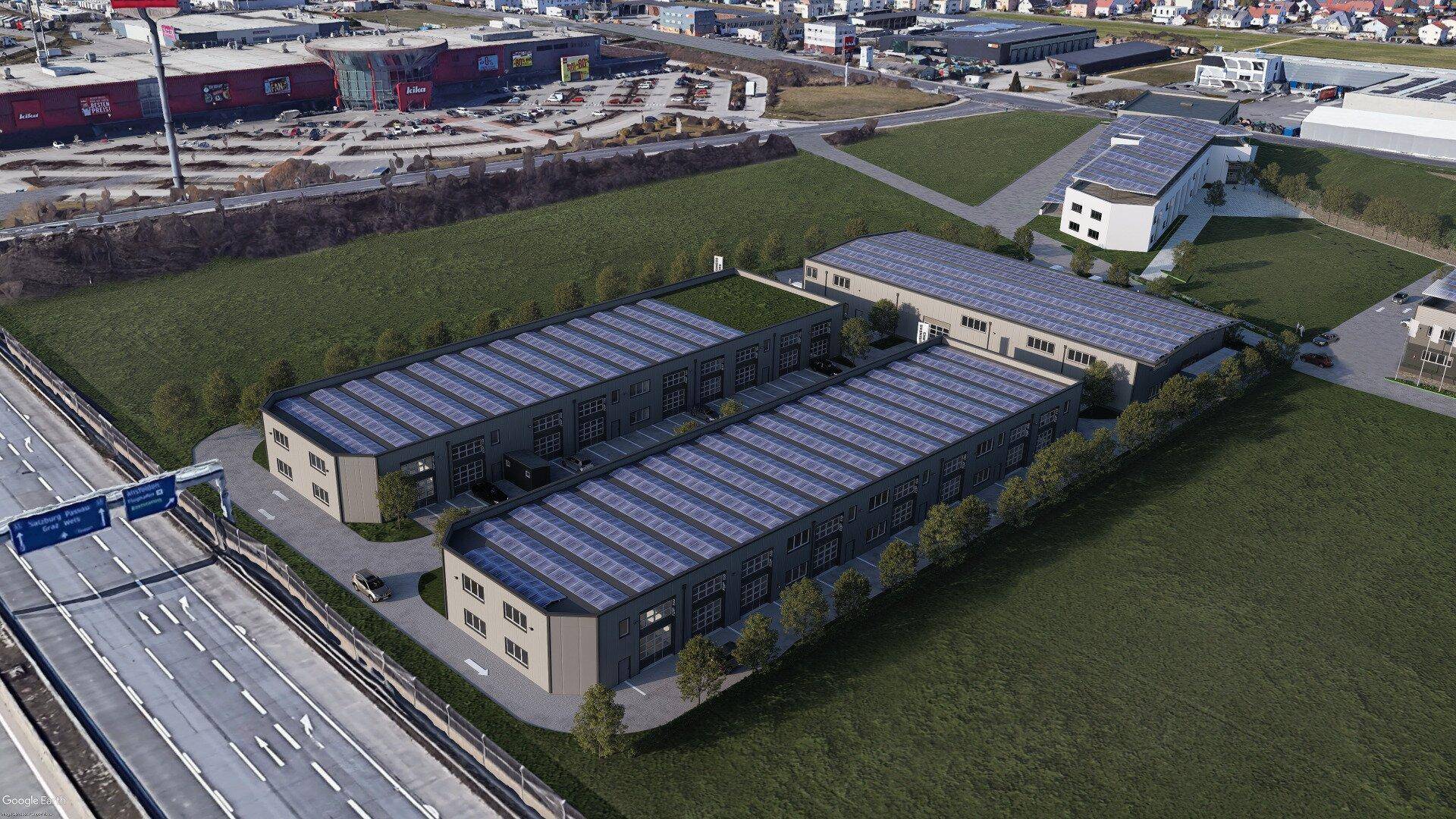 Übersicht aus der Vogelperspektive eines Gewerbeparks mit mehreren Hallen und Autobahnnähe.