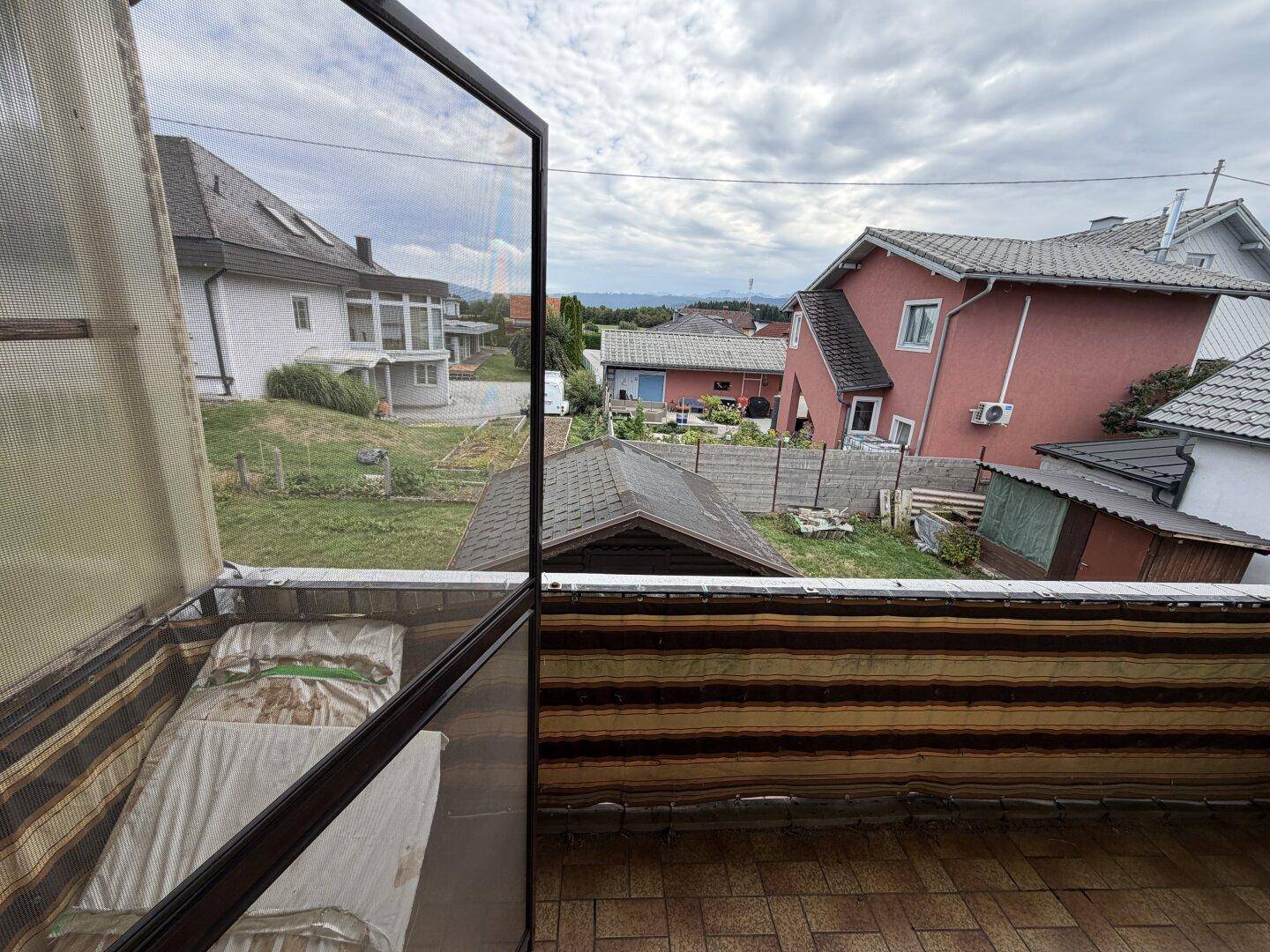 Kleiner Balkon mit Blick auf die umliegende Nachbarschaft und die Landschaft in der Ferne.