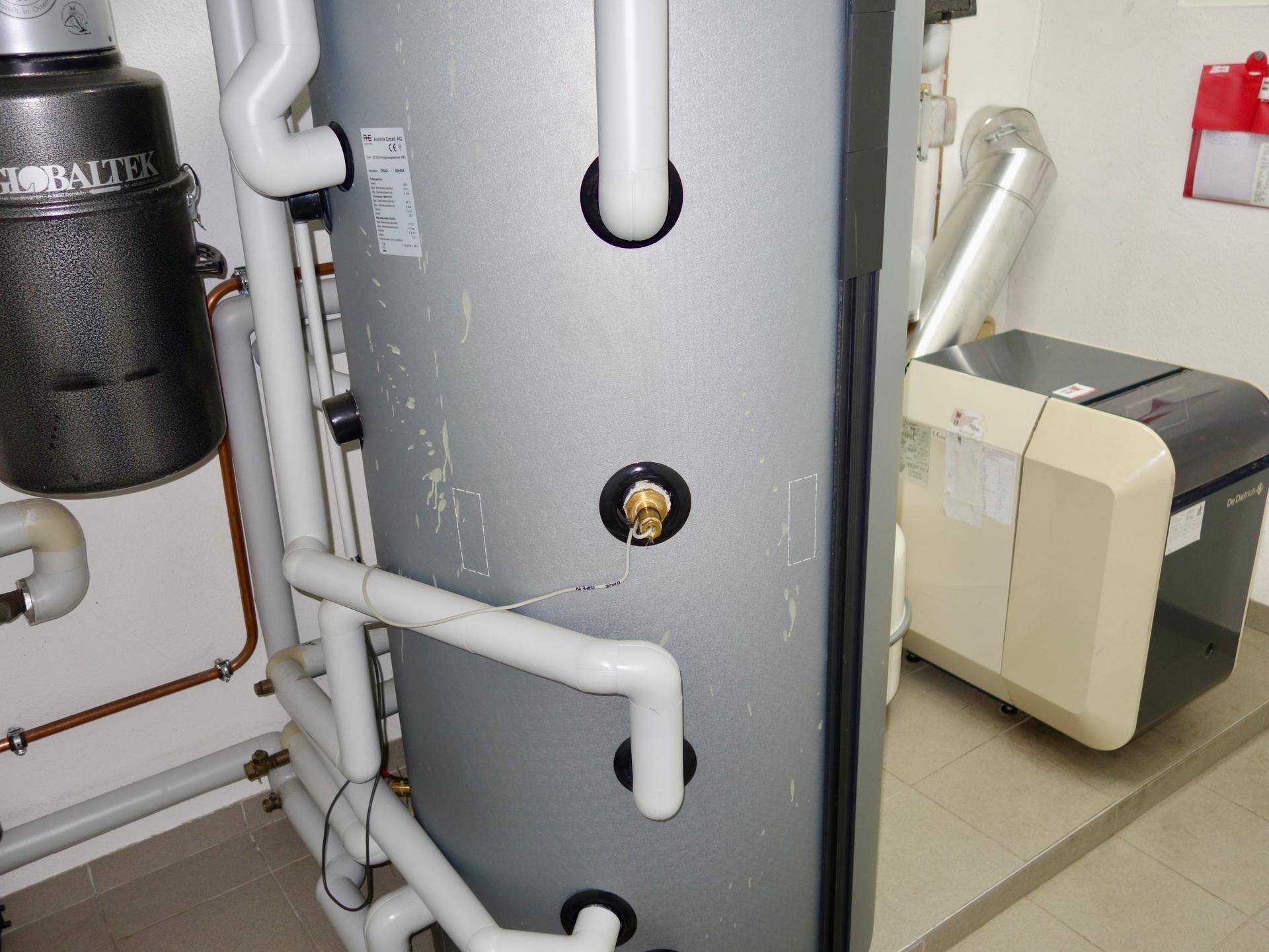Heizungsraum mit Warmwasserspeicher und moderner Heizungsanlage.
