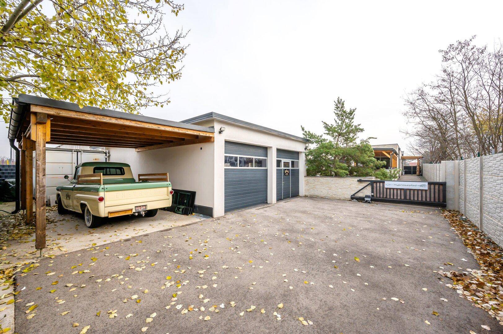 Einfahrt mit Carport und Garage