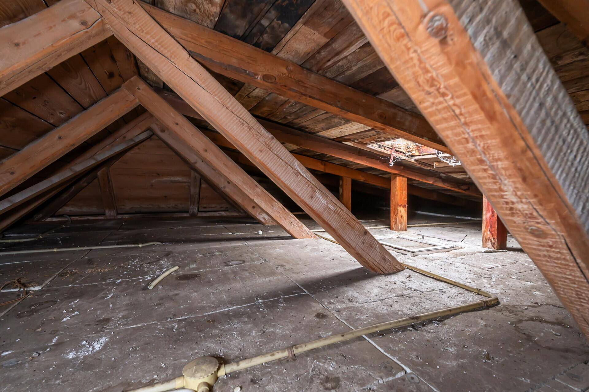 Geräumiger Dachboden mit sichtbaren Holzbalken und viel Stauraum.