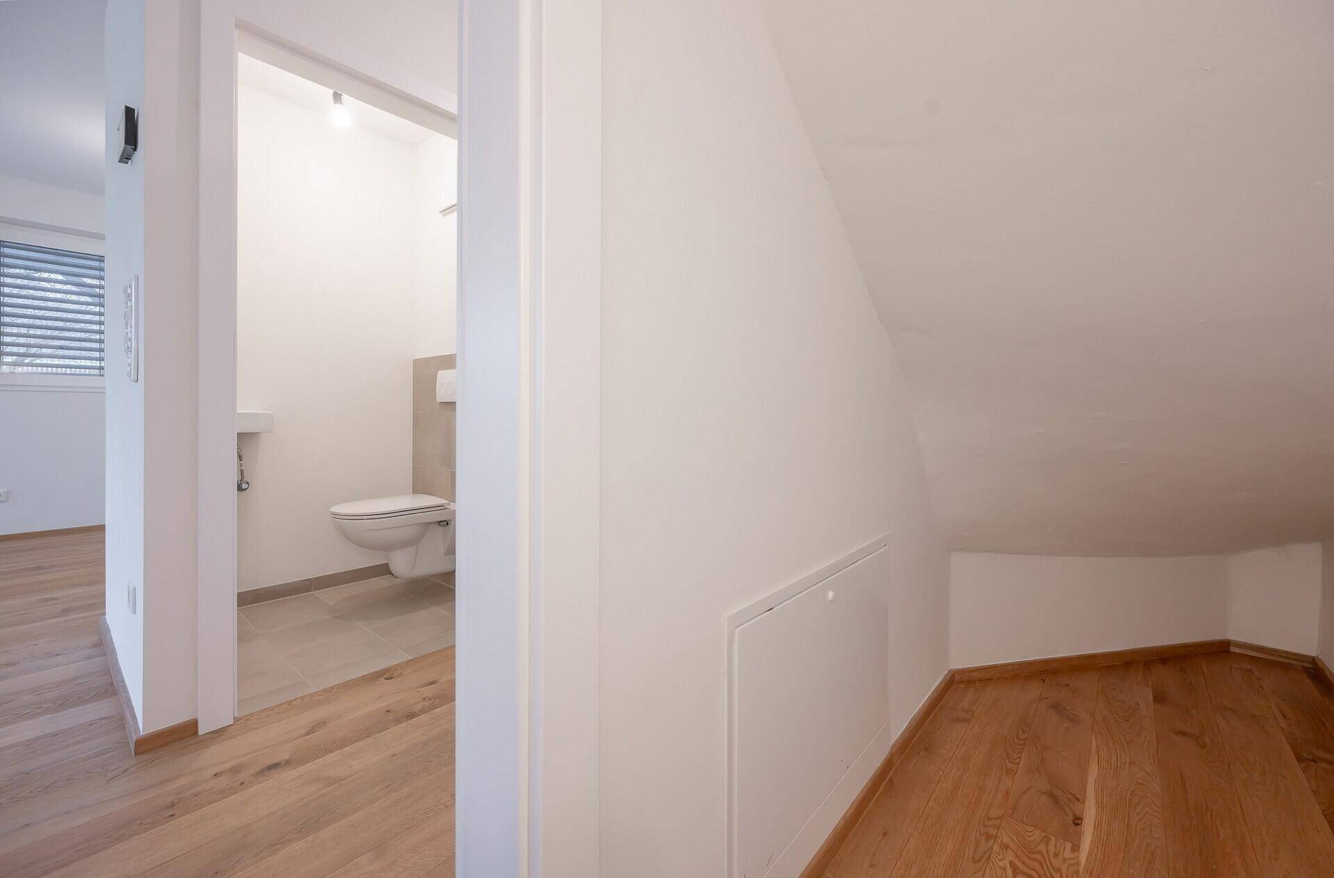 Praktischer Stauraum unter der Dachschräge mit Holzboden.