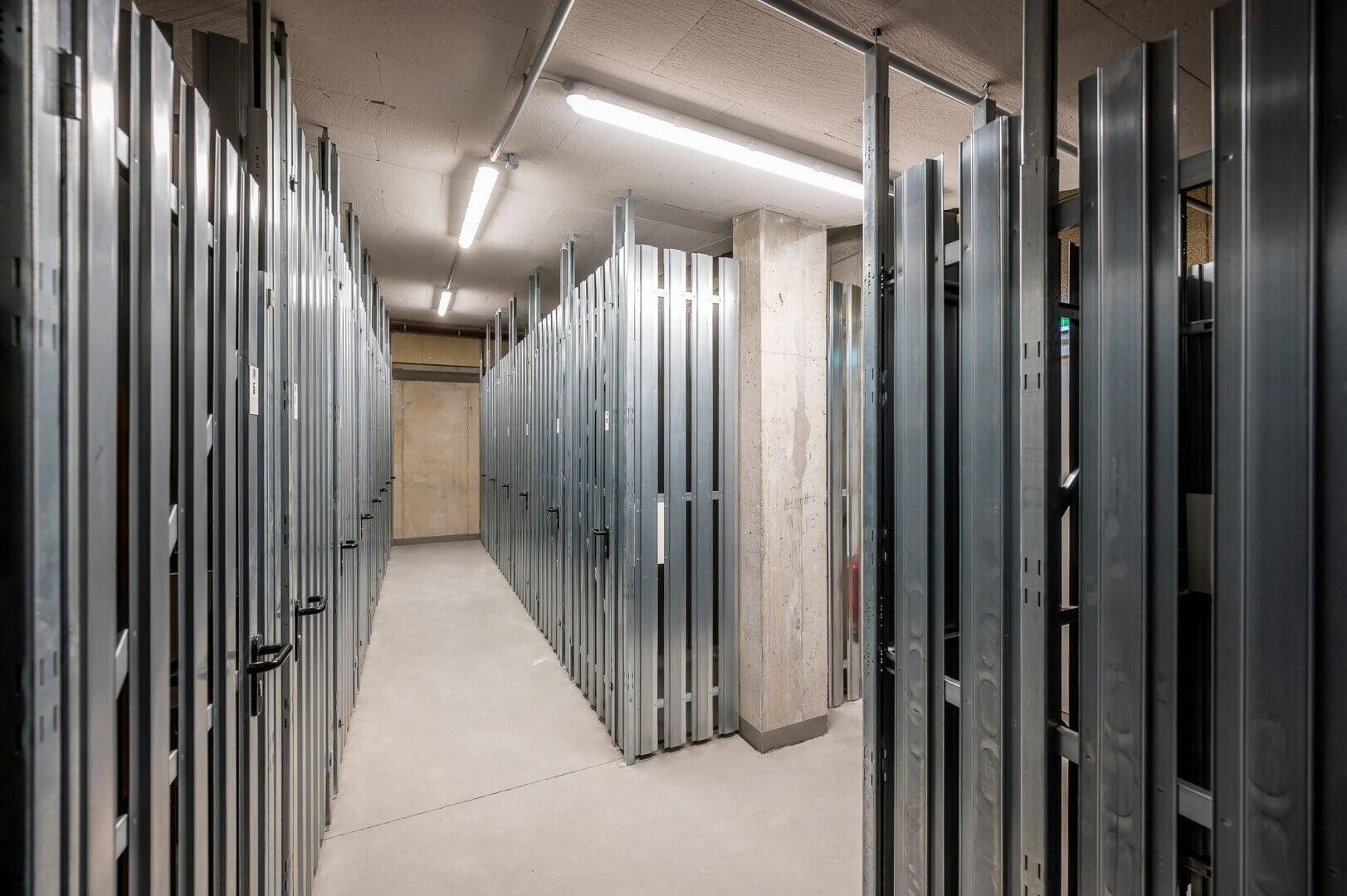 Kellerabteile mit Metallabtrennungen bieten sicheren Stauraum für persönliche Gegenstände der Bewohner.