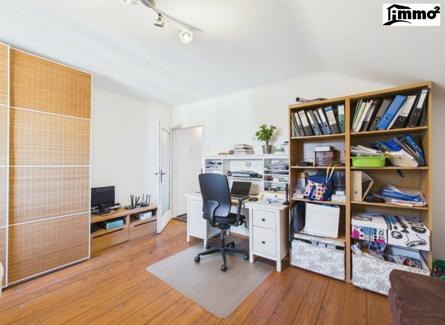 Geräumiges Arbeitszimmer im Dachgeschoss mit Holzboden und viel Stauraum.