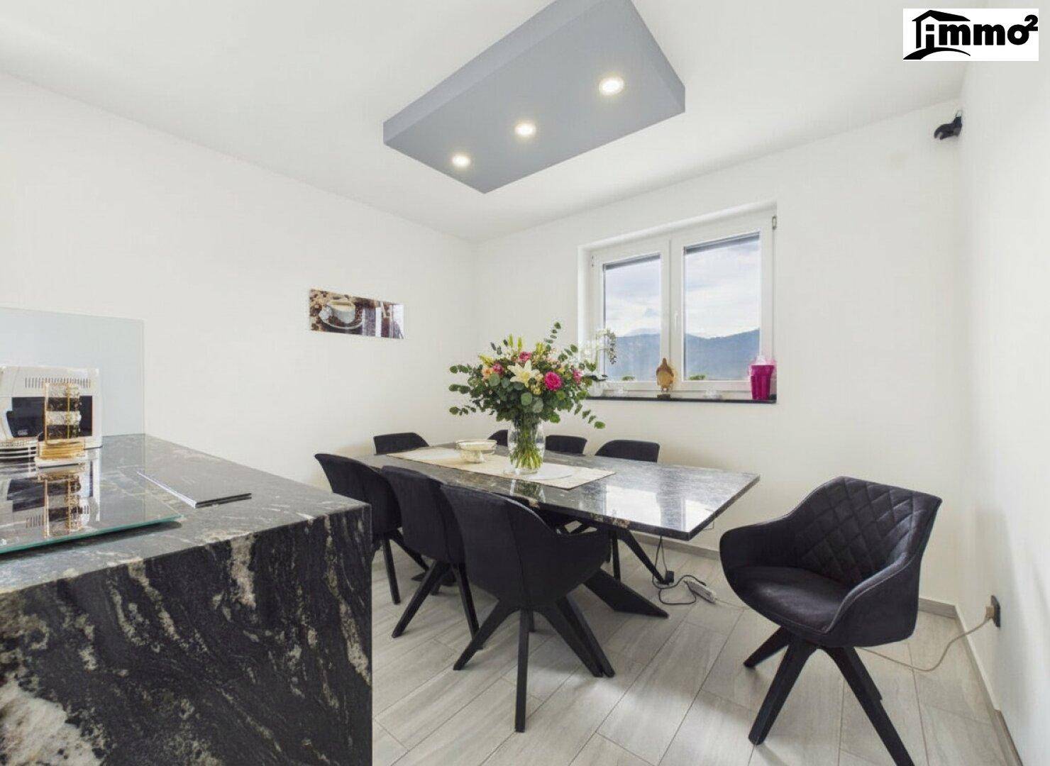 Eleganter Essbereich mit großem Granittisch und modernen Stühlen, direkt an der Küche gelegen.