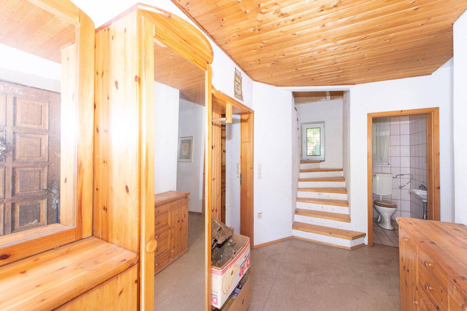 Flur mit Holzvertäfelung an Decke und Wänden sowie Zugang zu weiteren Räumen.
