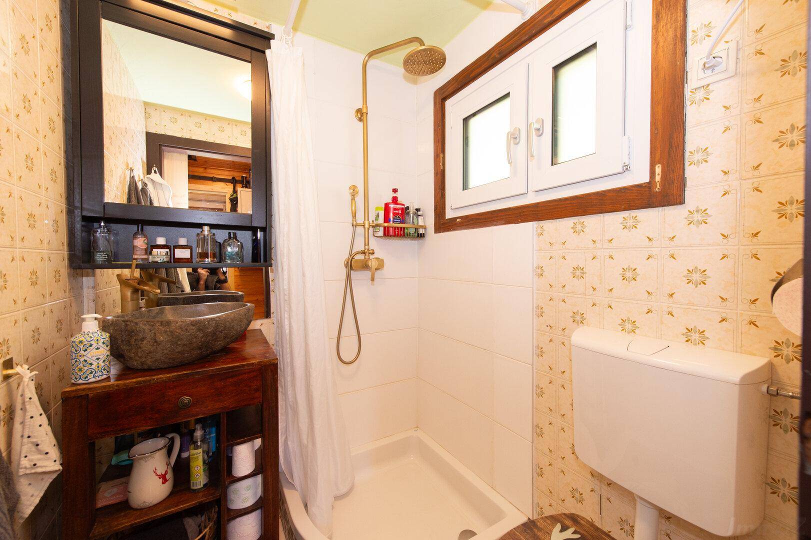 Kleines Badezimmer im Landhausstil mit Dusche, Fenster und rustikalen Fliesen.