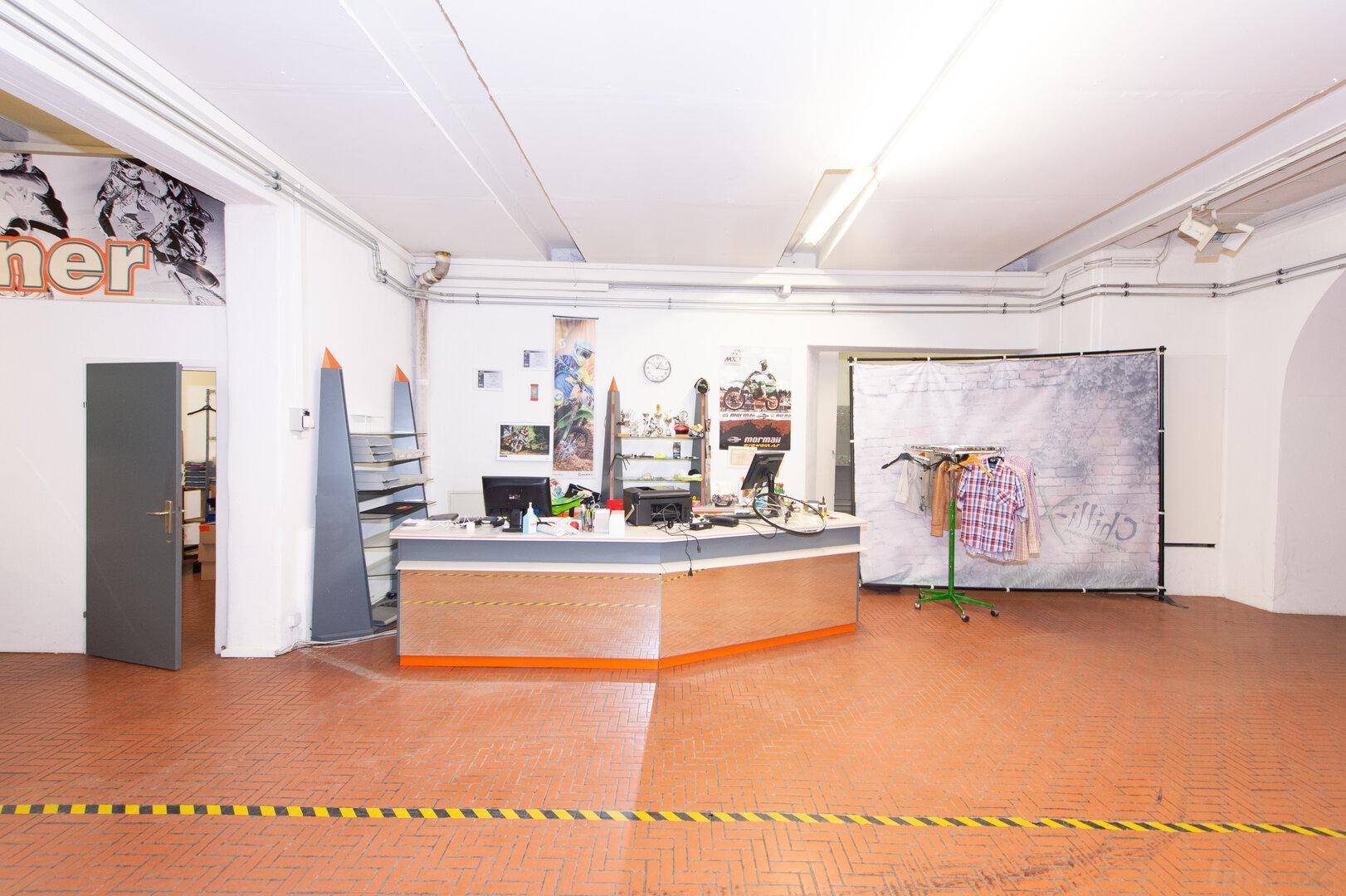 Empfangsbereich oder Büro in einem großen Raum mit Theke und Arbeitsplätzen.