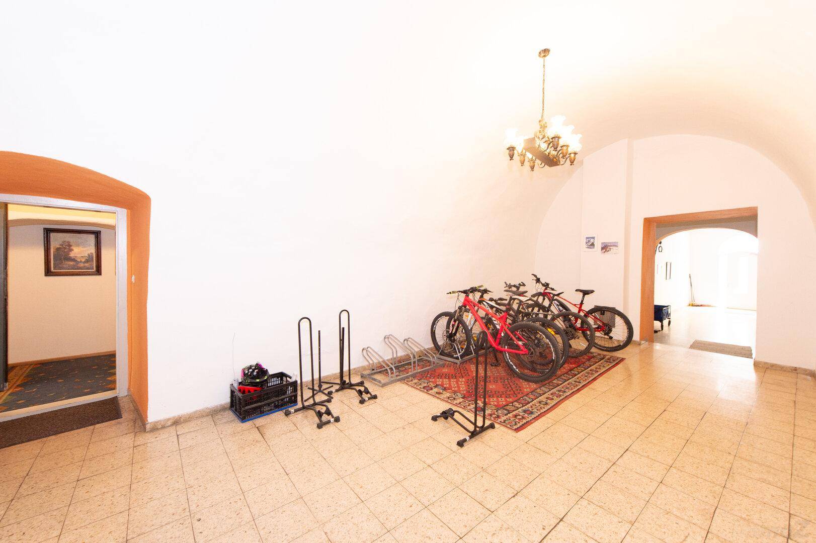 Geräumiger Eingangsbereich mit Fahrradständern und Kronleuchter, hell und funktional.
