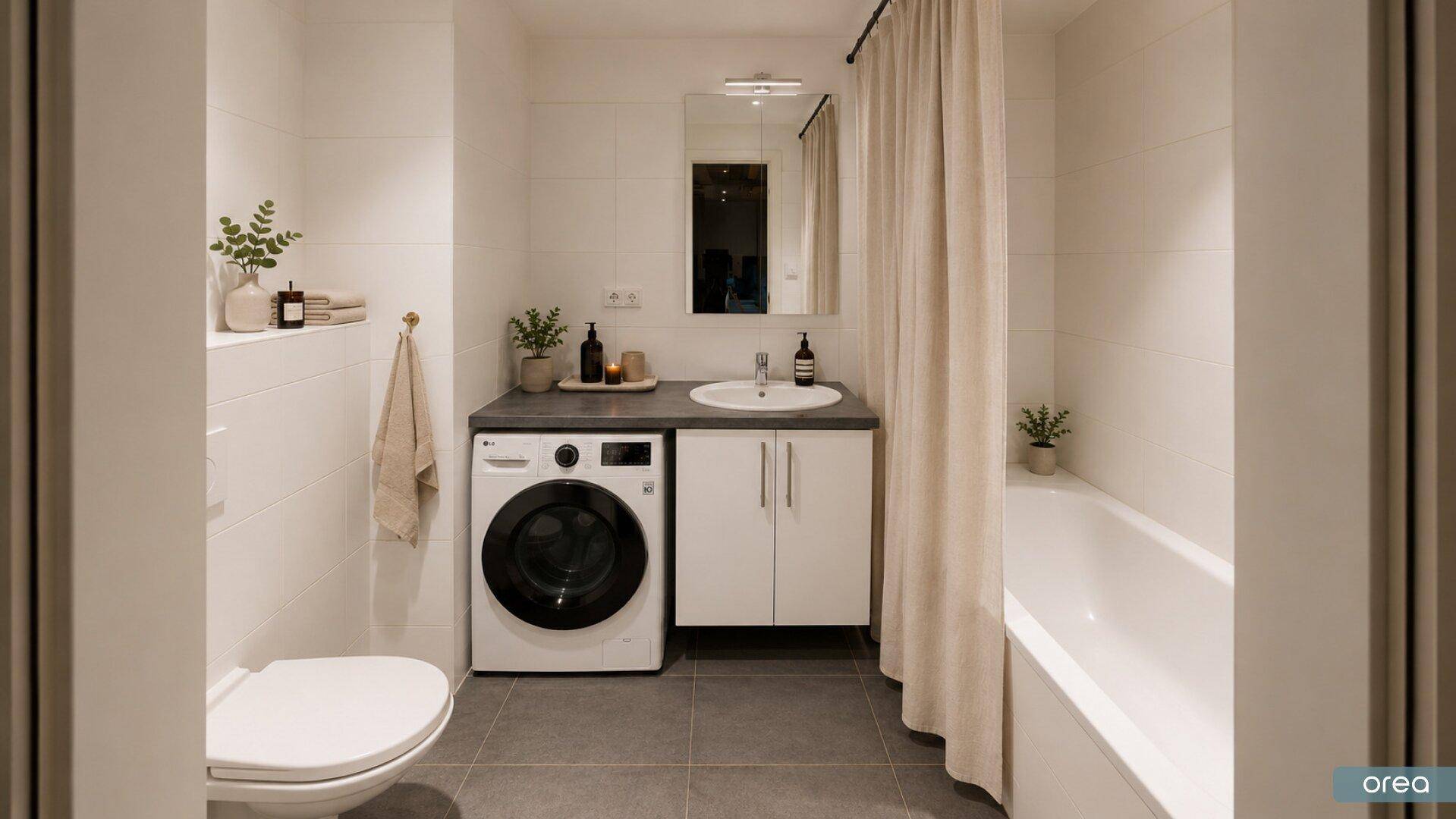 Modernes Badezimmer mit Badewanne, Waschmaschine und grauen Bodenfliesen.