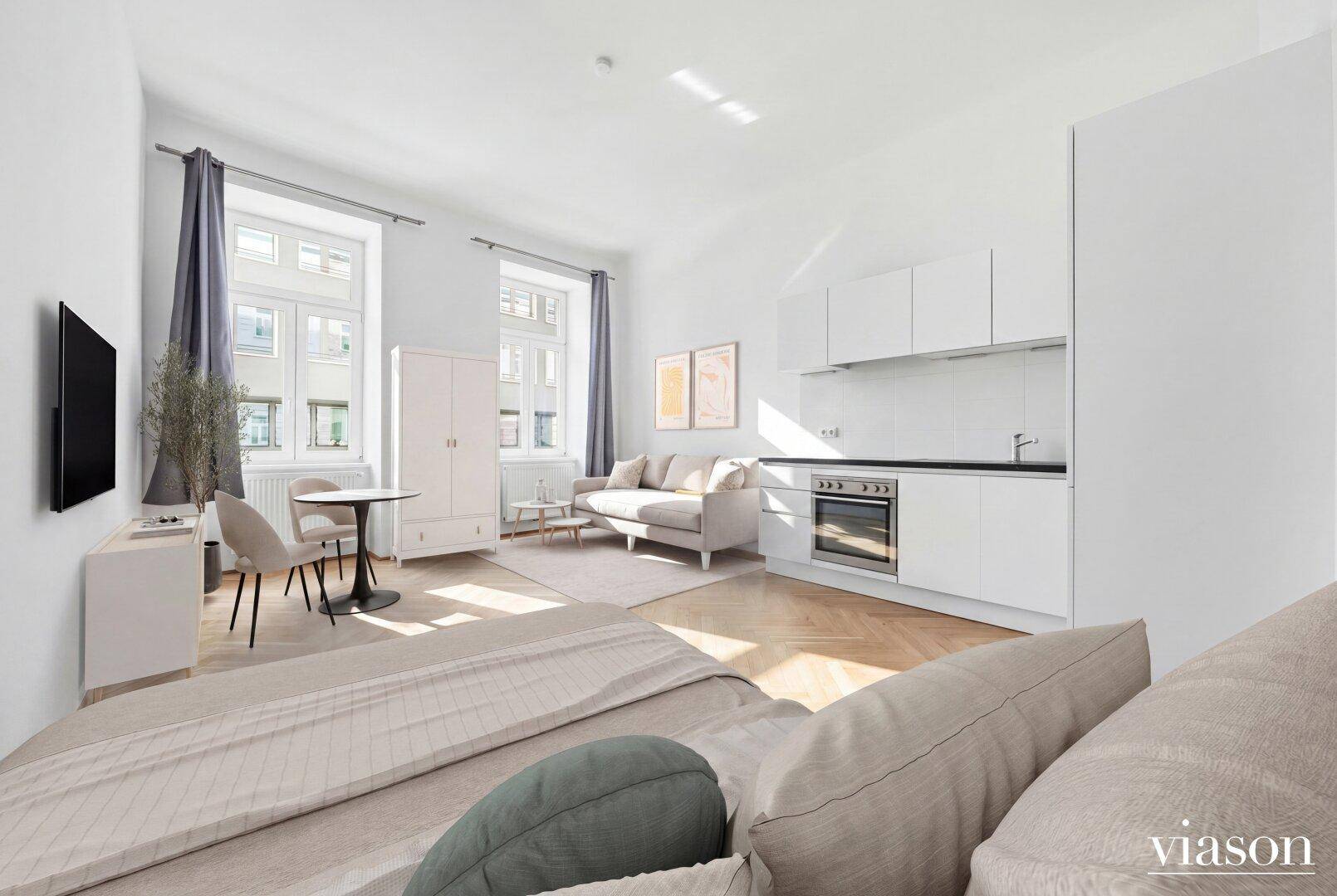 Modern eingerichtetes Studio-Apartment mit offener Küchenzeile, Essbereich und Schlafbereich.