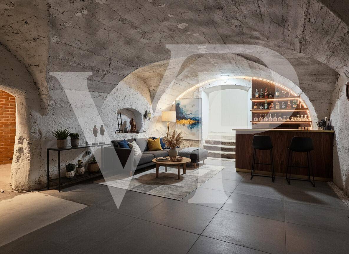 Modern eingerichteter Gewölbekeller mit Bar, Sofa und indirekter Beleuchtung, ideal als Partyraum.