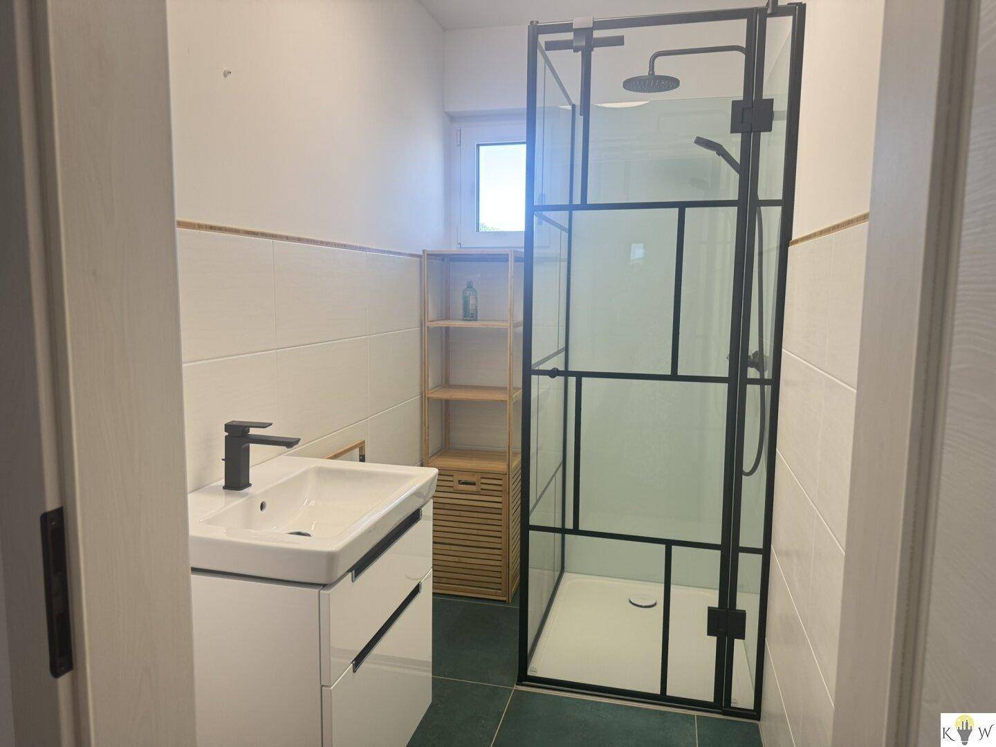 Modernes Badezimmer mit Duschkabine, Waschbecken und Fenster für Tageslicht.