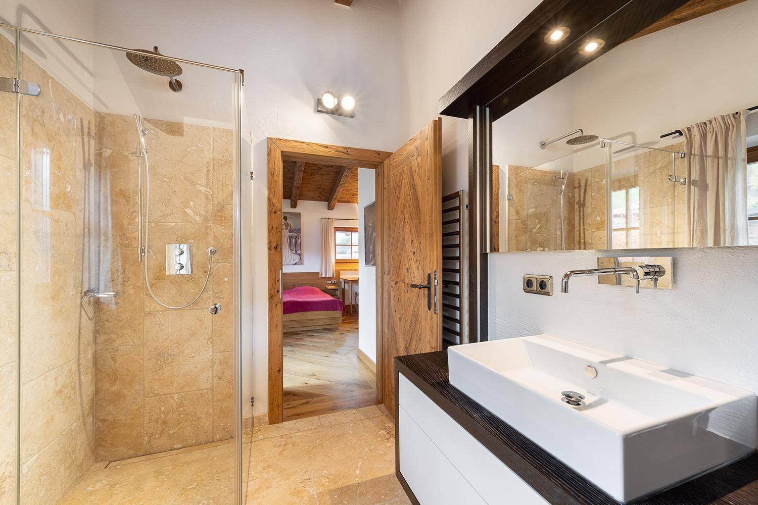 Modernes Badezimmer mit begehbarer Dusche, Einzelwaschbecken und Natursteinfliesen.