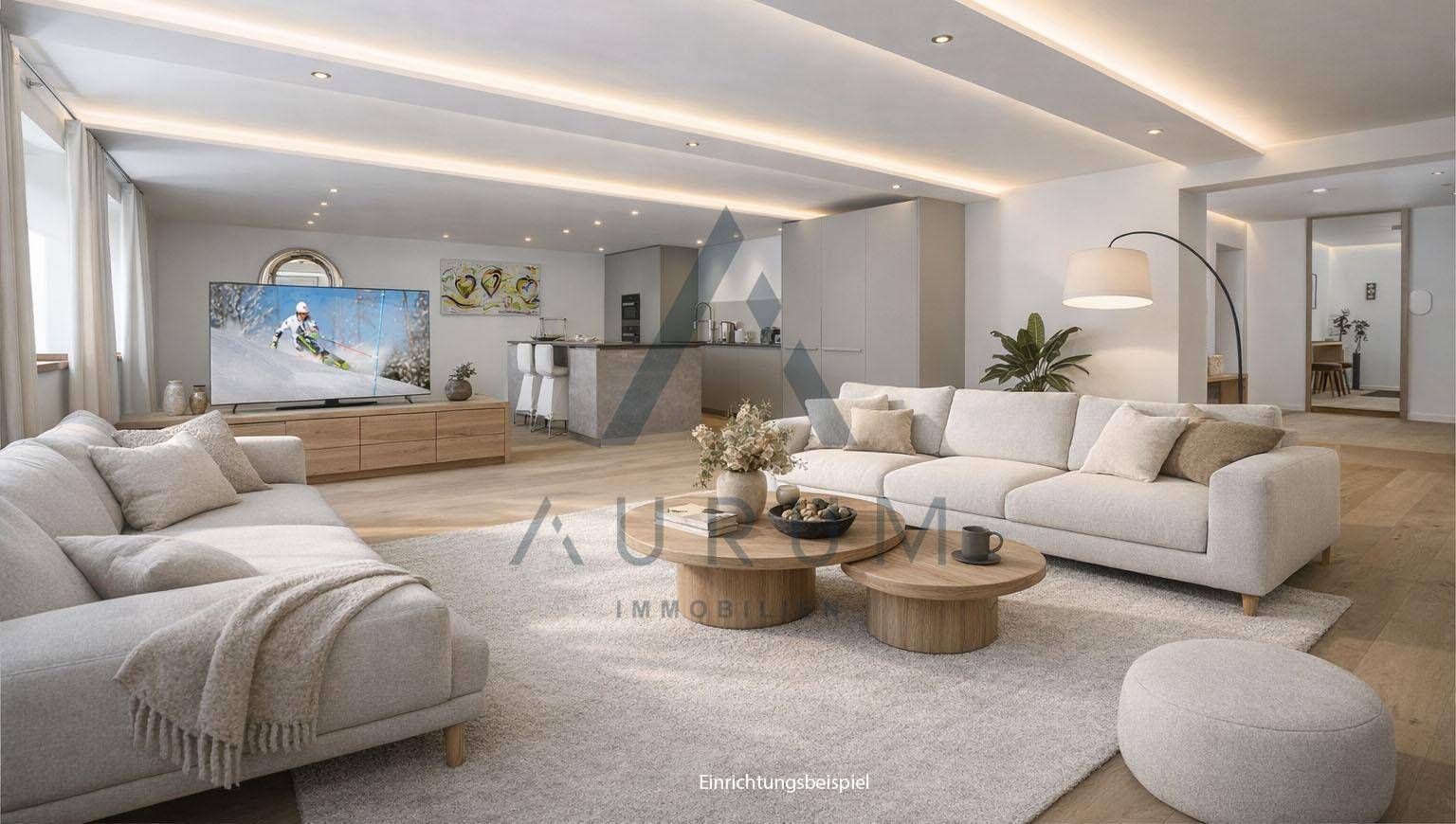 Geräumiger, offener Wohnbereich mit moderner Küche, hellen Sofas und Holzboden, ideal für geselliges Beisammensein.