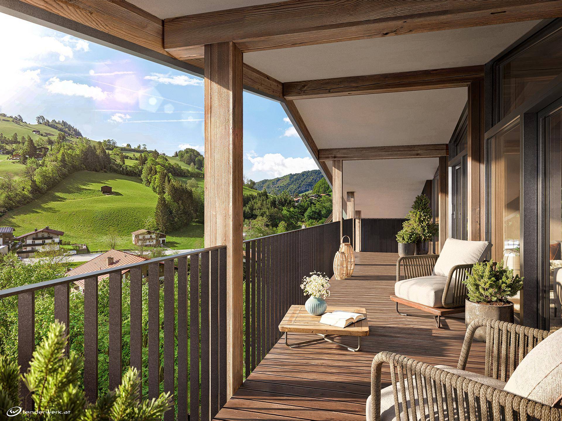 Geräumiger Balkon mit Holzboden und Sitzgelegenheiten, bietet einen weiten Blick auf die grüne Berglandschaft.