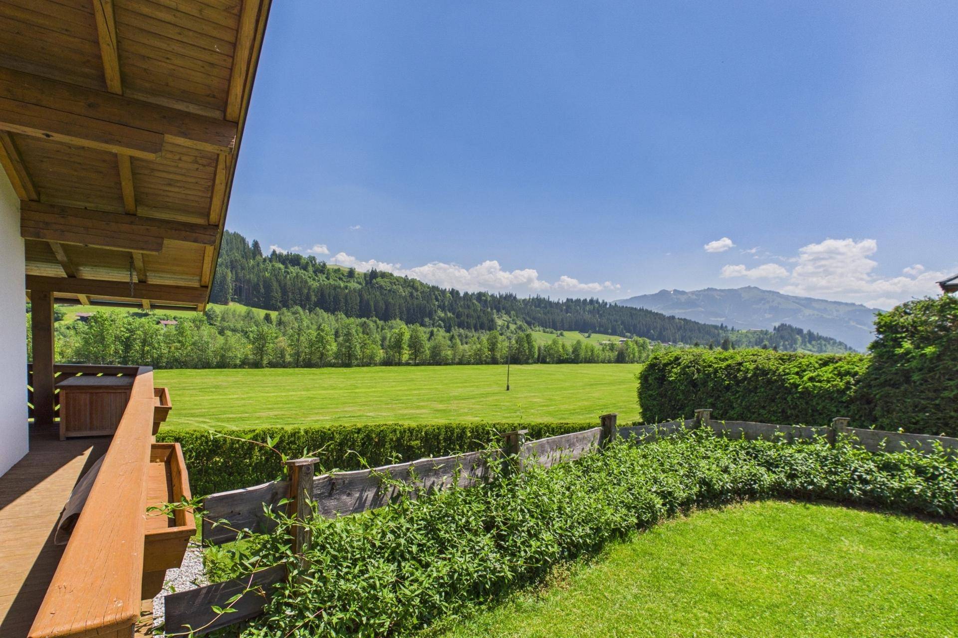 Weitläufiger Gartenbereich mit Rasenfläche und Blick auf die umliegende Natur.