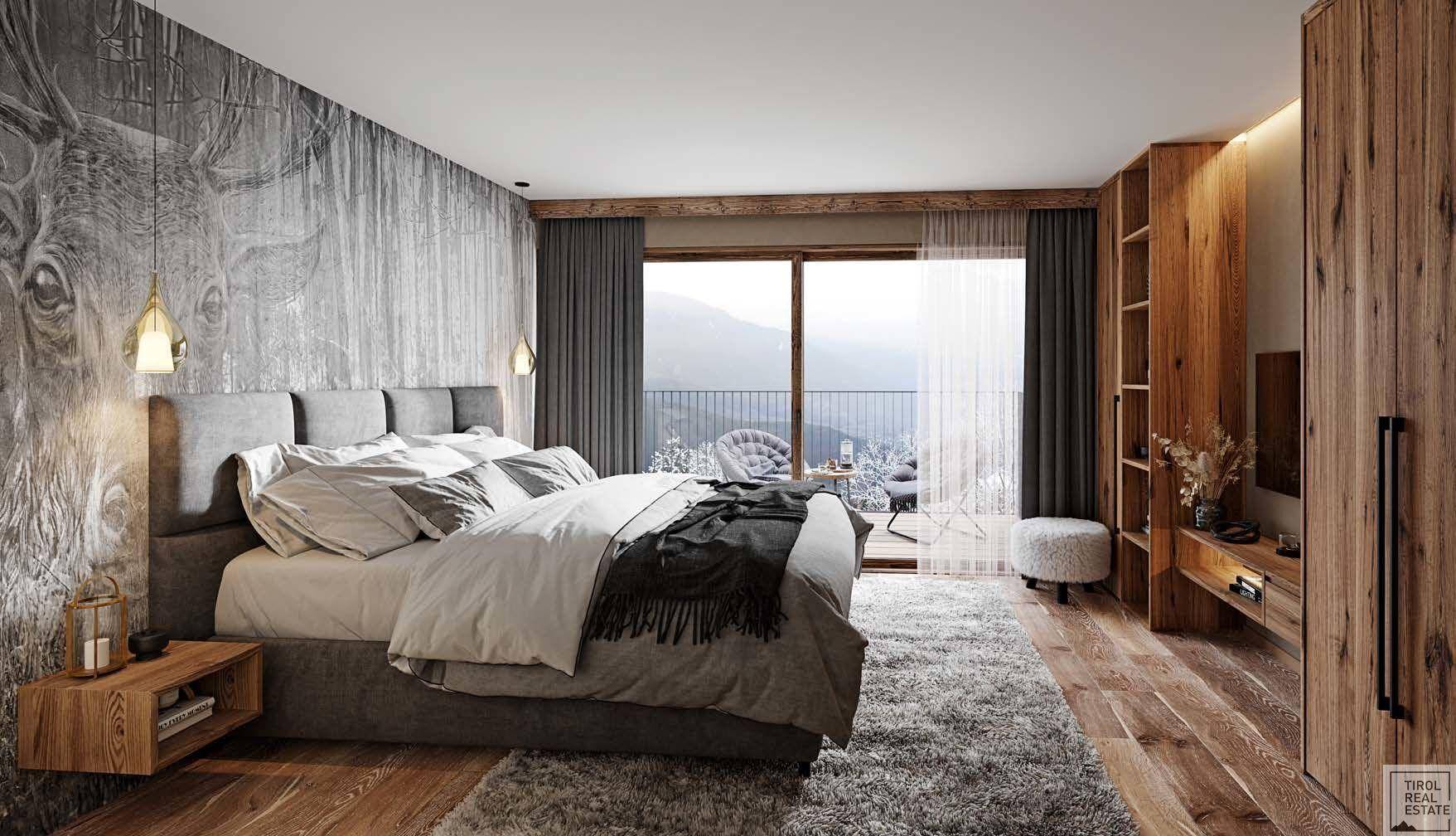 Modernes Schlafzimmer mit Holzboden, Zugang zum Balkon und beeindruckendem Blick auf die Bergwelt.
