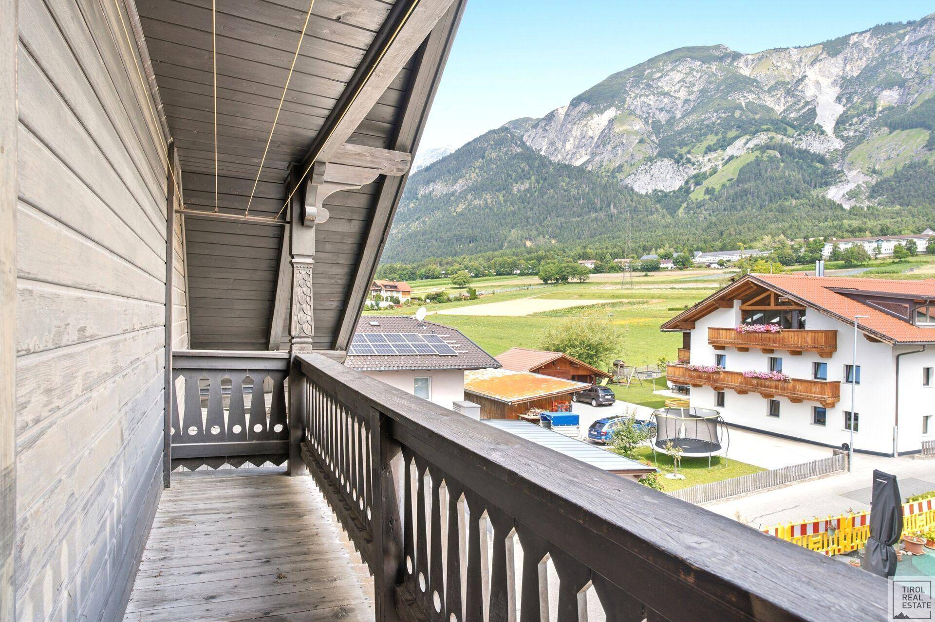 Geräumiger Holzbalkon mit atemberaubendem Bergblick und Weitsicht.