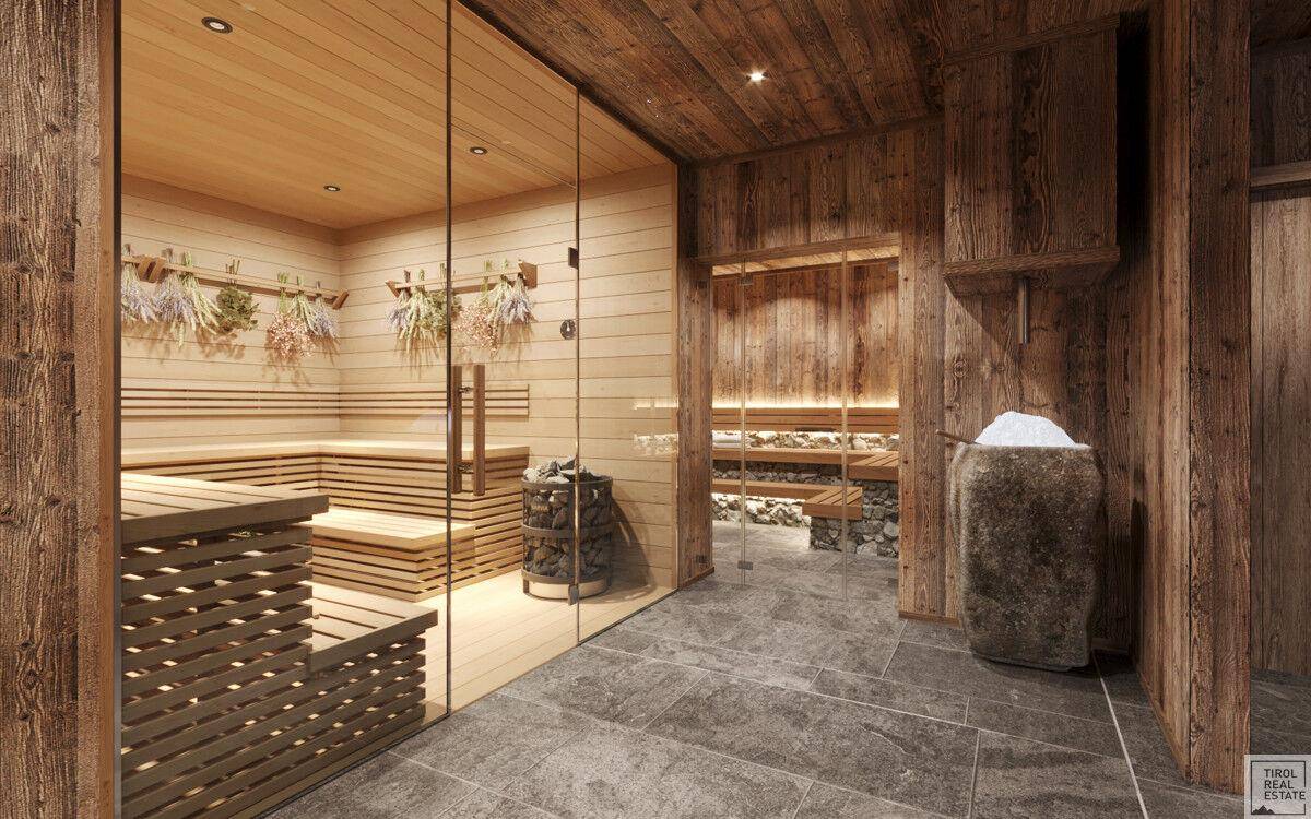 Geräumige Sauna mit Holzverkleidung, Steinofen und einem Eimer Schnee für die Abkühlung.