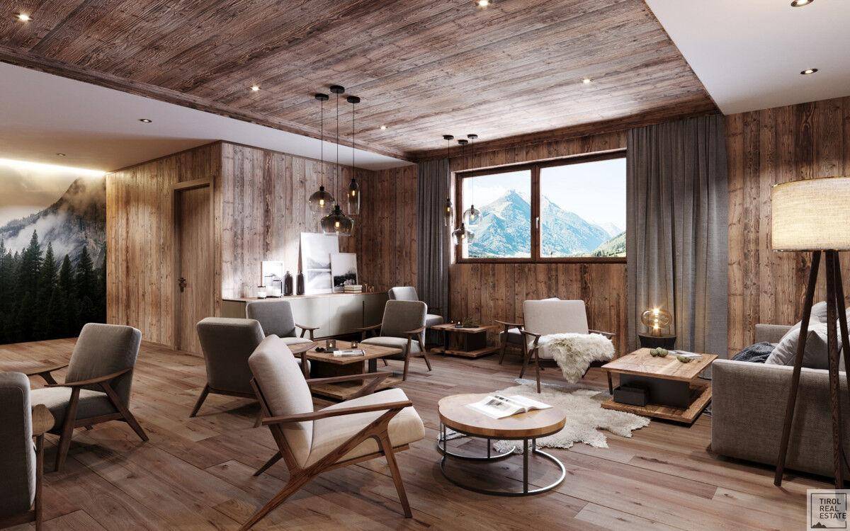 Helles Wohnzimmer mit Holzboden, bequemen Sesseln und großem Fenster mit Bergblick.