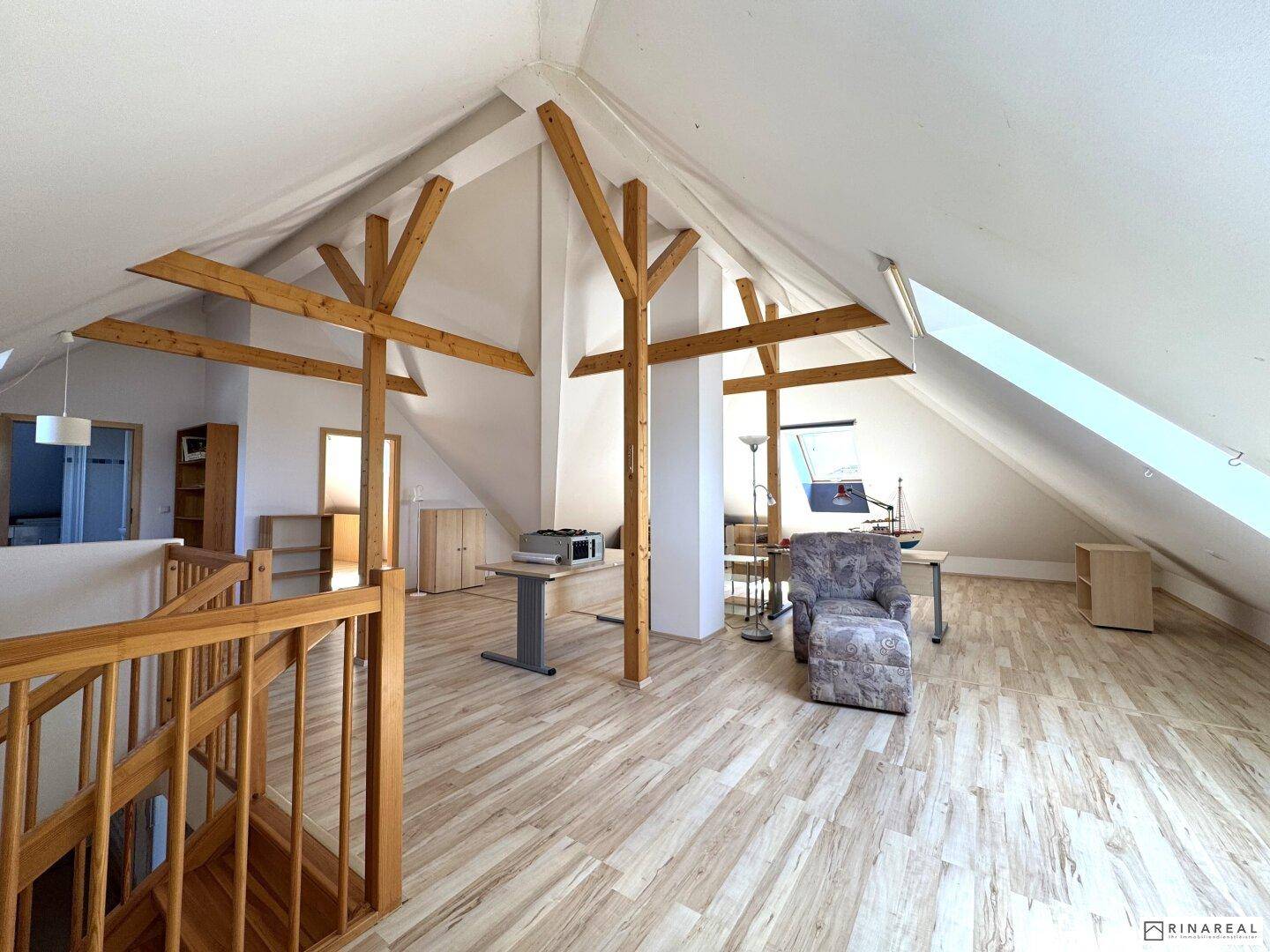 Großzügiger Dachbodenbereich mit Holzbalken, Laminatboden und vielseitiger Nutzungsmöglichkeit.